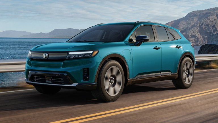 A new Honda Prologue EV driving on a coastal road.